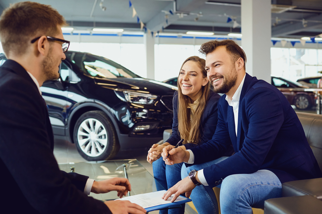 Couple Buys a Car in a Car Dealership